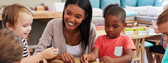 educator smiling at children